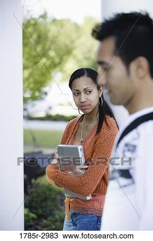 Two students standing View Large Photo Image Stock Image - Two students standing. Fotosearch
