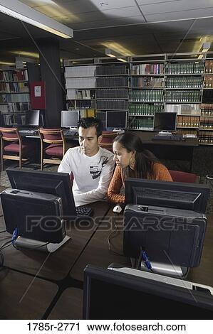Two university students using computers in the library View Large Photo Image Stock Image - Two university students using computers in the library. Fotosearch