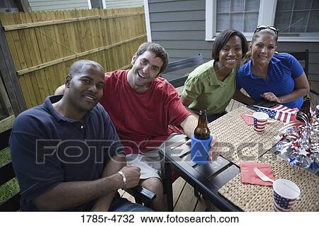 Two young couples on backyard patio on 4th of July View Large Photo Image Stock Image - Two young couples on backyard patio on 4th of July. Fotosearch