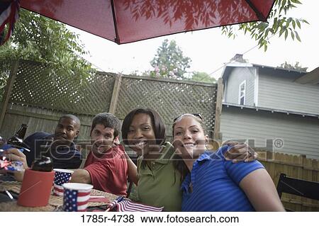 Two young couples on backyard patio on 4th of July View Large Photo Image Stock Photo - Two young couples on backyard patio on 4th of July. Fotosearch