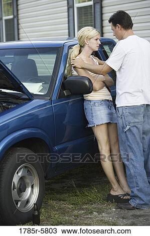 Unhappy couple conversing while leaning against old truck, in front of trailer home View Large Photo Image Stock Image - Unhappy couple conversing while leaning against old truck, in front of trailer home. Fotosearch