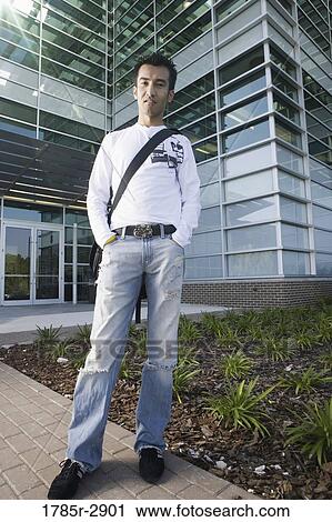 University student standing outside campus building View Large Photo Image Stock Image - University student standing outside campus building. Fotosearch