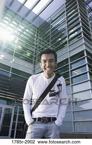 University student standing outside campus building View Large Photo Image Stock Image - University student standing outside campus building. Fotosearch