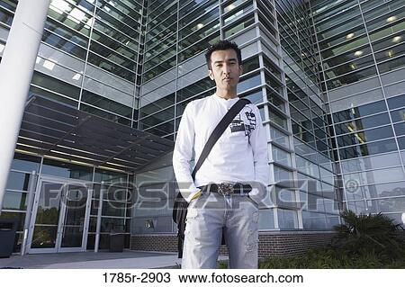 University student standing outside campus building View Large Photo Image Stock Image - University student standing outside campus building. Fotosearch