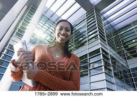 University student standing outside campus building View Large Photo Image Stock Photo - University student standing outside campus building. Fotosearch
