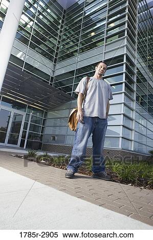 University student standing outside campus building View Large Photo Image Stock Photography - University student standing outside campus building. Fotosearch