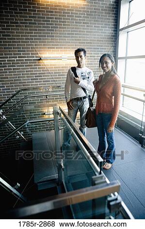 Stock Photo - University students standing on stairway between classes. Fotosearch