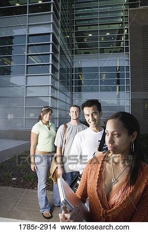University students standing outside campus building View Large Photo Image Picture - University students standing outside campus building. Fotosearch