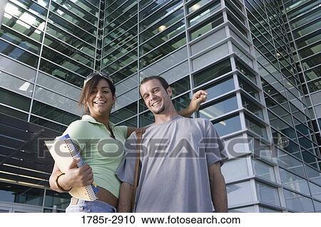 University students standing outside campus building View Large Photo Image Stock Image - University students standing outside campus building. Fotosearch