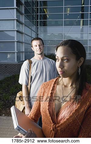University students standing outside campus building View Large Photo Image Stock Image - University students standing outside campus building. Fotosearch