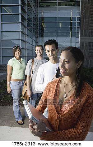 University students standing outside campus building View Large Photo Image Stock Image - University students standing outside campus building. Fotosearch