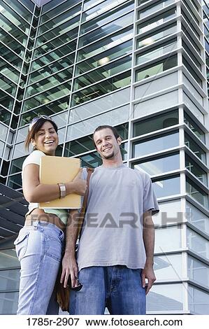 University students standing outside campus building View Large Photo Image Stock Photo - University students standing outside campus building. Fotosearch