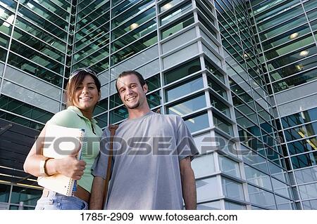 Stock Photo - University students standing outside campus building. Fotosearch