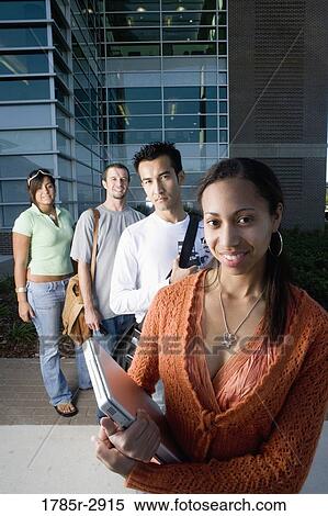 University students standing outside campus building View Large Photo Image Stock Photography - University students standing outside campus building. Fotosearch
