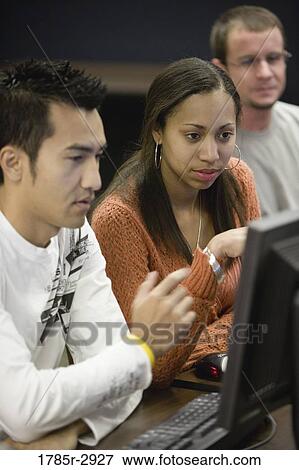University students using computer View Large Photo Image Stock Photo - University students using computer. Fotosearch