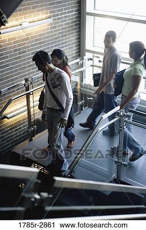 University students walking downstairs between classes View Large Photo Image Stock Image - University students walking downstairs between classes. Fotosearch