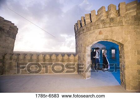 View of a navy officer and a princess standing in a castle turret View Large Photo Image Stock Image - View of a navy officer and a princess standing in a castle turret. Fotosearch