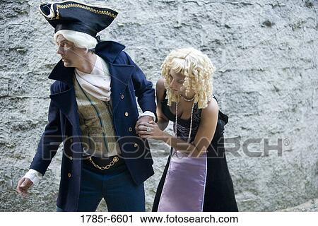 View of a navy officer and a princess sneaking around a castle wall View Large Photo Image Stock Image - View of a navy officer and a princess sneaking around a castle wall. Fotosearch