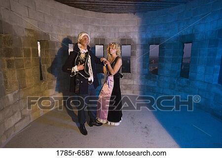 View of a navy officer and a princess standing in a castle turret View Large Photo Image Stock Photo - View of a navy officer and a princess standing in a castle turret. Fotosearch