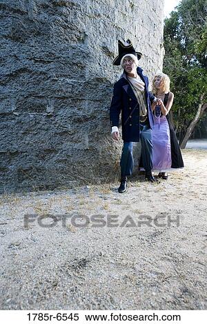View of a navy officer and a princess sneaking around a castle wall View Large Photo Image Stock Photography - View of a navy officer and a princess sneaking around a castle wall. Fotosearch