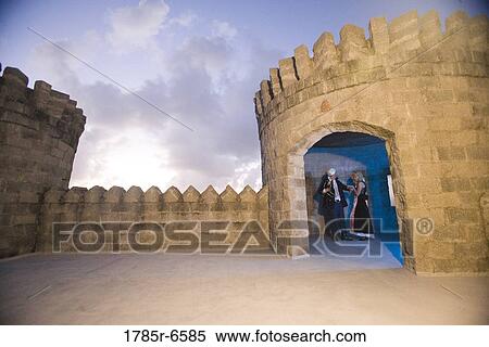 View of a navy officer and a princess standing in a castle turret View Large Photo Image Stock Photography - View of a navy officer and a princess standing in a castle turret. Fotosearch