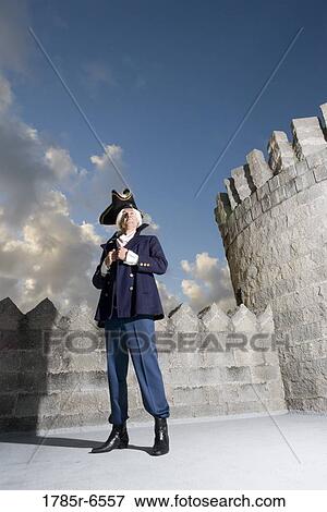 View of a navy officer with castle turrets and parapets in the background View Large Photo Image Stock Photo - View of a navy officer with castle turrets and parapets in the background. Fotosearch