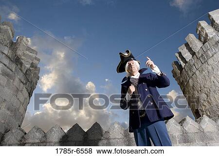 View of a navy officer with castle turrets and parapets in the background View Large Photo Image Stock Photo - View of a navy officer with castle turrets and parapets in the background. Fotosearch