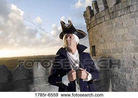 Stock Photo - View of a navy officer with castle turrets and parapets in the background. Fotosearch