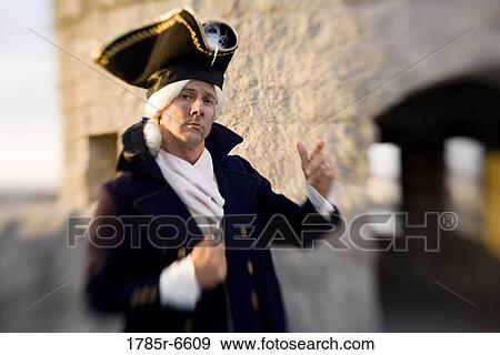 View of a navy officer with castle wall and turrets in the background View Large Photo Image Stock Photo - View of a navy officer with castle wall and turrets in the background. Fotosearch