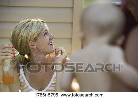 View of a smiling woman looking up View Large Photo Image Stock Photography - View of a smiling woman looking up. Fotosearch