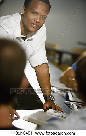 View of a teacher teaching in the classroom View Large Photo Image Stock Image - View of a teacher teaching in the classroom. Fotosearch