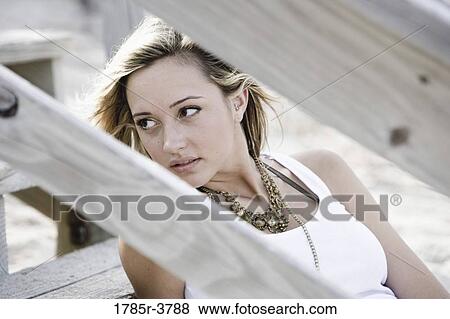 View of a young woman sitting on steps View Large Photo Image Stock Photo - View of a young woman sitting on steps. Fotosearch