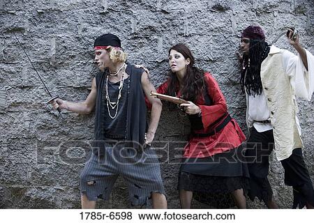 View of armed pirates sneaking around a castle wall View Large Photo Image Stock Photo - View of armed pirates sneaking around a castle wall. Fotosearch