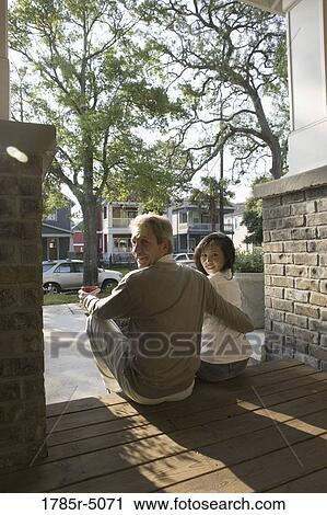 View of interracial couple sitting on front steps of house View Large Photo Image Stock Image - View of interracial couple sitting on front steps of house. Fotosearch