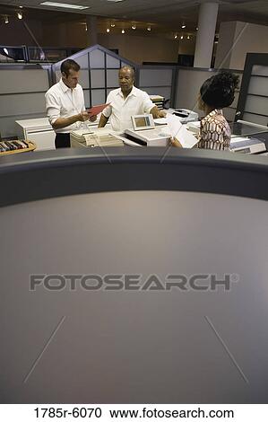 View of office worker at copy machine over cubicle wall View Large Photo Image Stock Image - View of office worker at copy machine over cubicle wall. Fotosearch