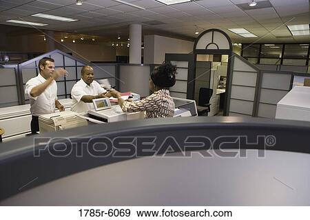 View of office worker at copy machine over cubicle wall View Large Photo Image Stock Photo - View of office worker at copy machine over cubicle wall. Fotosearch