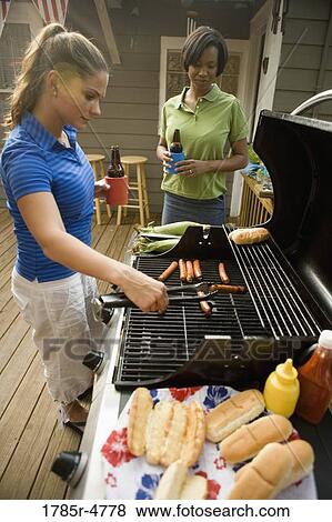 View of two women cooking on outdoor grill View Large Photo Image Stock Photo - View of two women cooking on outdoor grill. Fotosearch