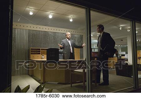 View through window of businessmen in an office having discussion View Large Photo Image Stock Image - View through window of businessmen in an office having discussion. Fotosearch