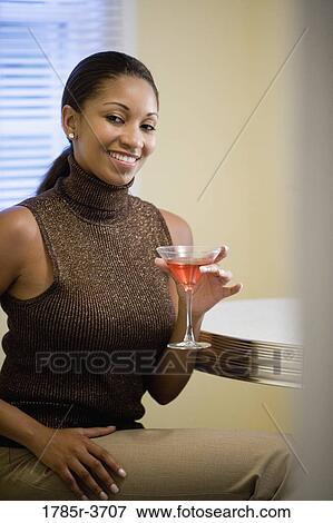Woman holding a cocktail View Large Photo Image Stock Photo - Woman holding a cocktail. Fotosearch