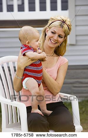 Woman holding her baby View Large Photo Image Stock Photo - Woman holding her baby. Fotosearch