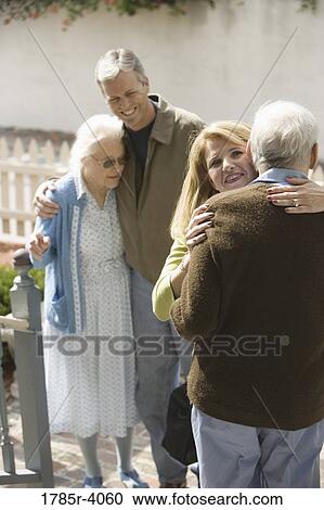 Woman hugging senior man while man and senior woman watch View Large Photo Image Stock Image - Woman hugging senior man while man and senior woman watch. Fotosearch