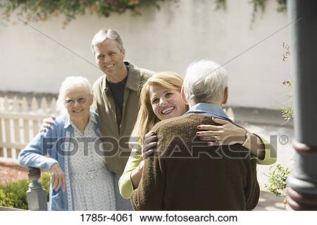 Woman hugging senior man while man and senior woman watch View Large Photo Image Stock Image - Woman hugging senior man while man and senior woman watch. Fotosearch