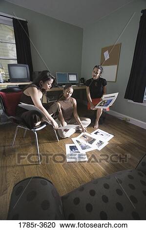 Stock Image - Women entrepreneurs working in office. Fotosearch