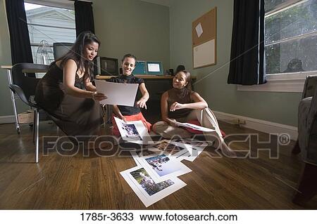 Stock Image - Women entrepreneurs working in office. Fotosearch