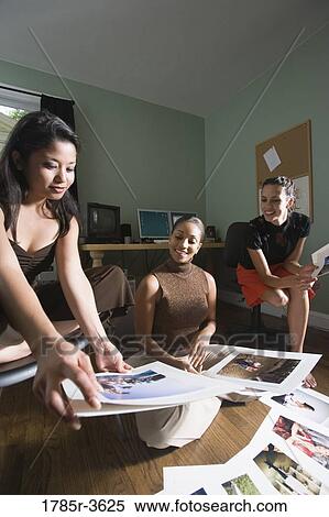 Stock Photography - Women entrepreneurs working in office. Fotosearch