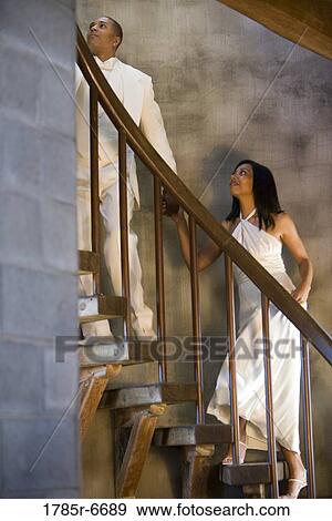 Young bride and groom ascending spiral staircase View Large Photo Image Stock Photo - Young bride and groom ascending spiral staircase. Fotosearch