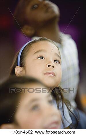 Young children watching and listening attentively View Large Photo Image Stock Image - Young children watching and listening attentively. Fotosearch