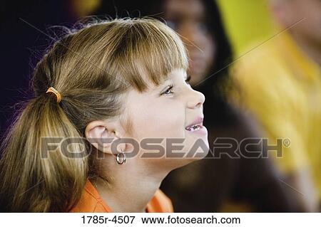 Young children watching and listening attentively View Large Photo Image Stock Photo - Young children watching and listening attentively. Fotosearch