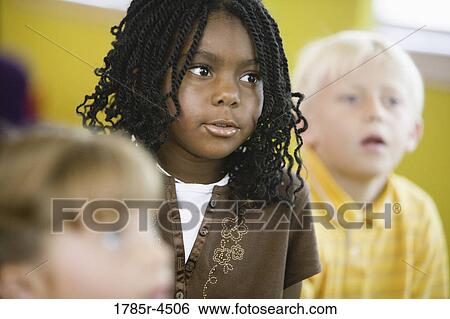 Stock Photograph - Young children watching and listening attentively. Fotosearch