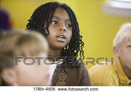 Young children watching and listening attentively View Large Photo Image Stock Photography - Young children watching and listening attentively. Fotosearch